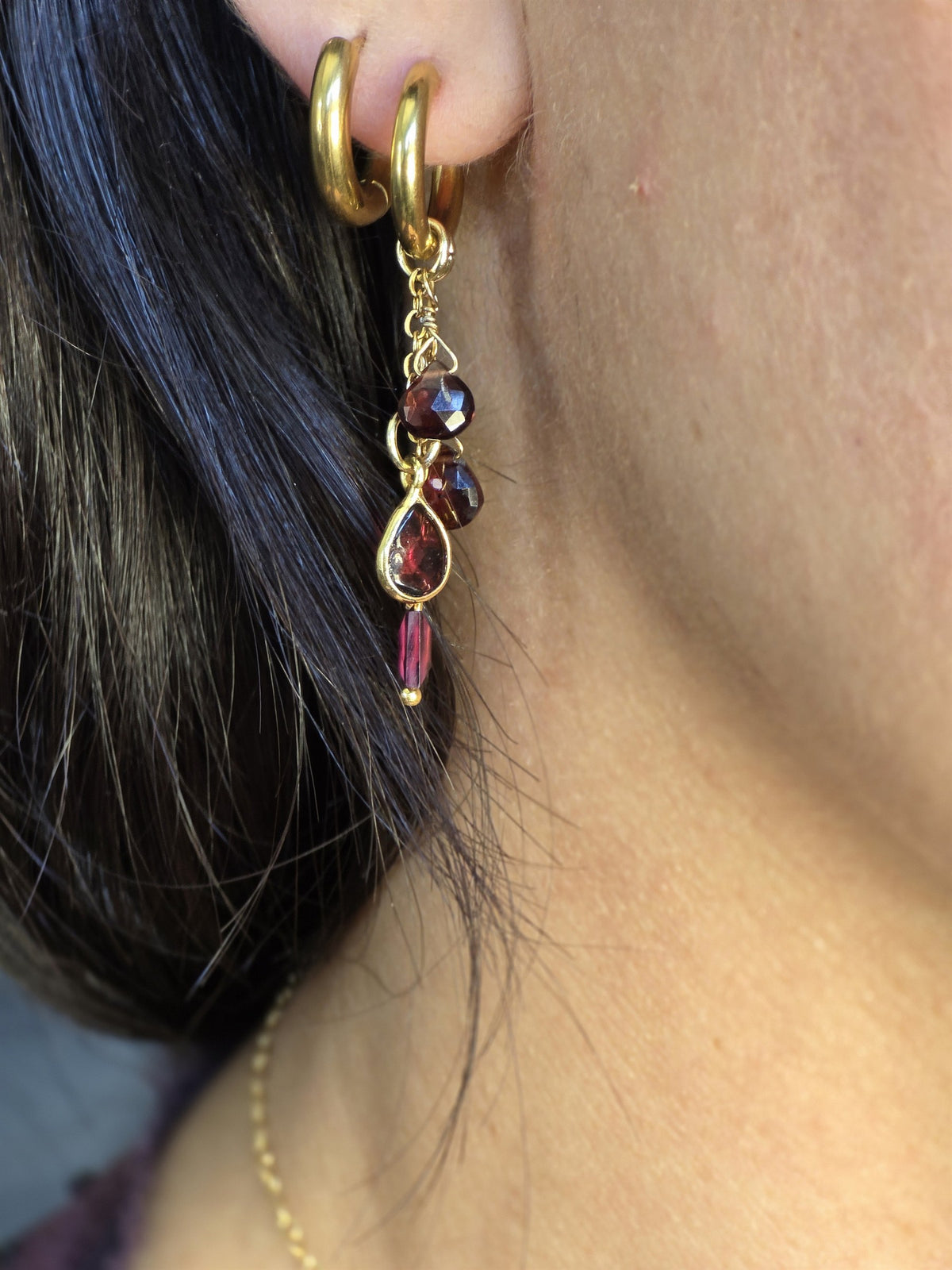 Garnet drop earring worn, side view