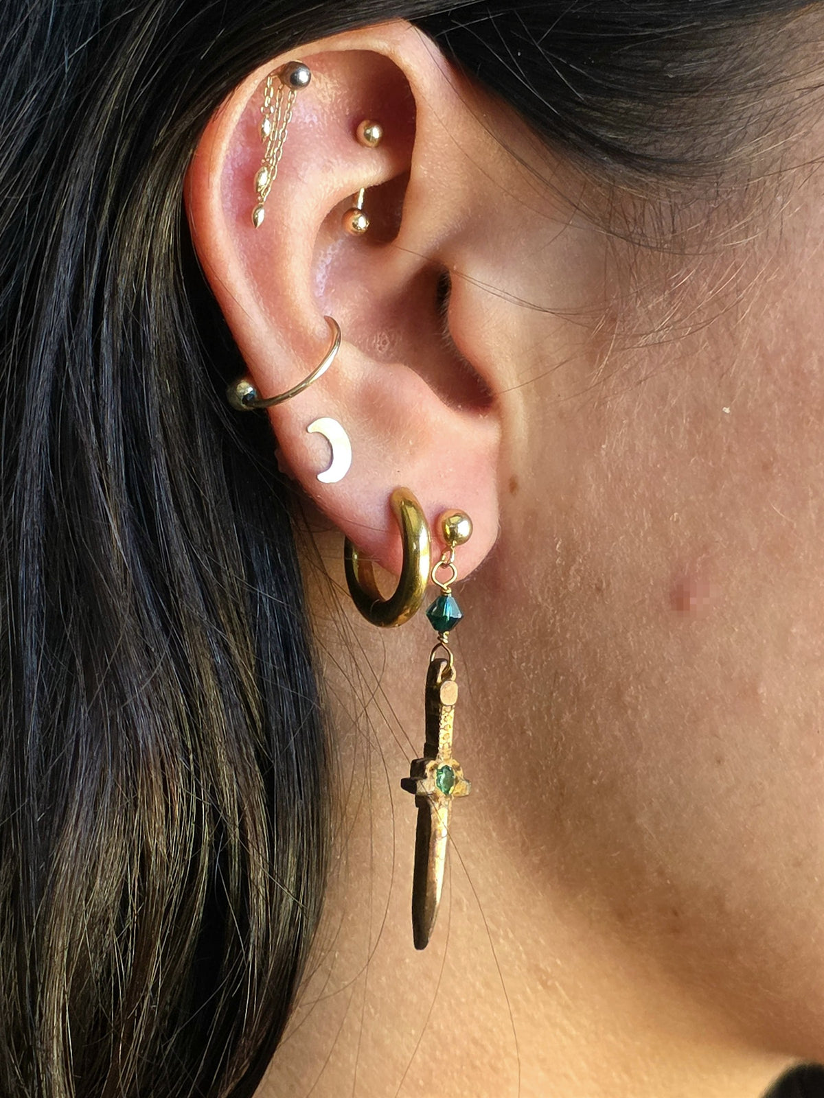 Bronze dagger earring worn, showing length