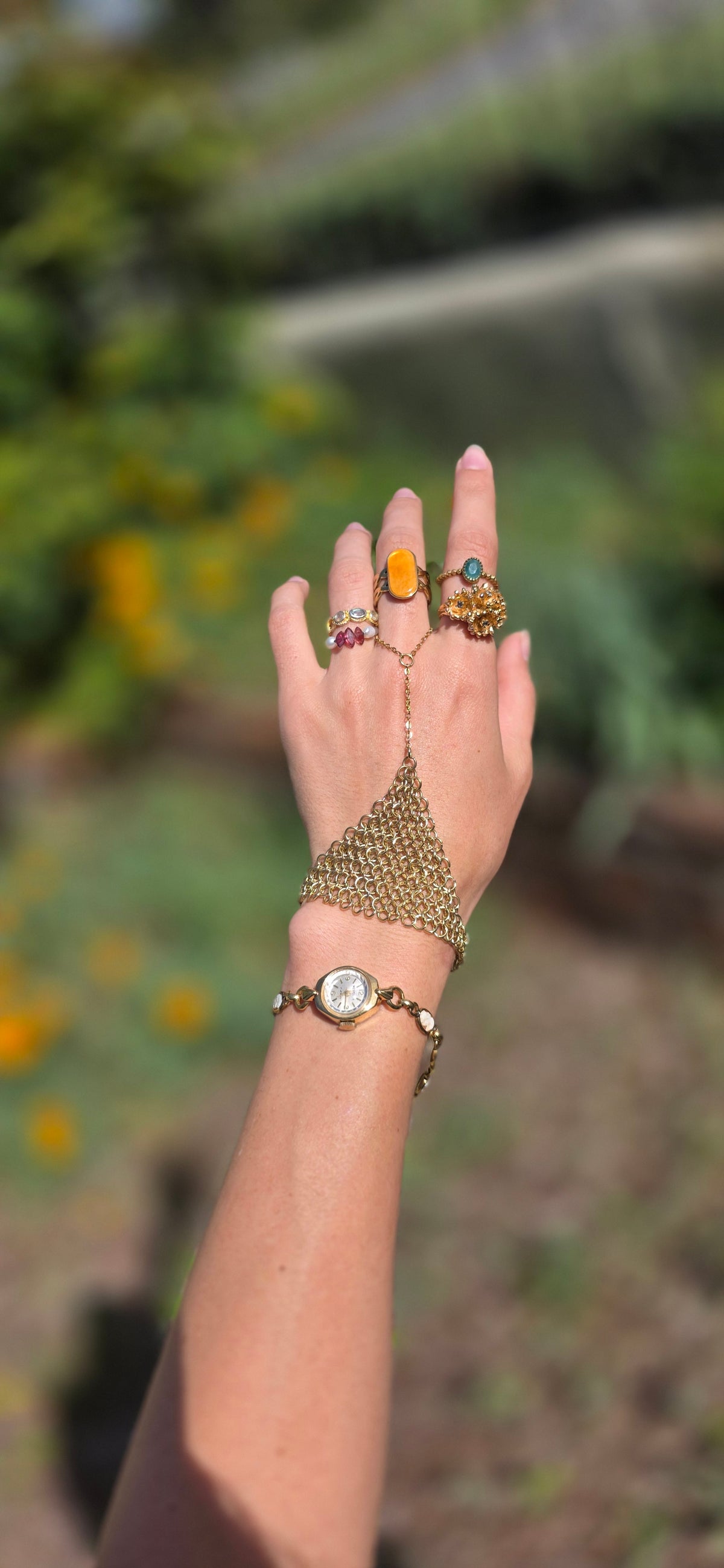Gold chainmaille hand chain styled on the hand