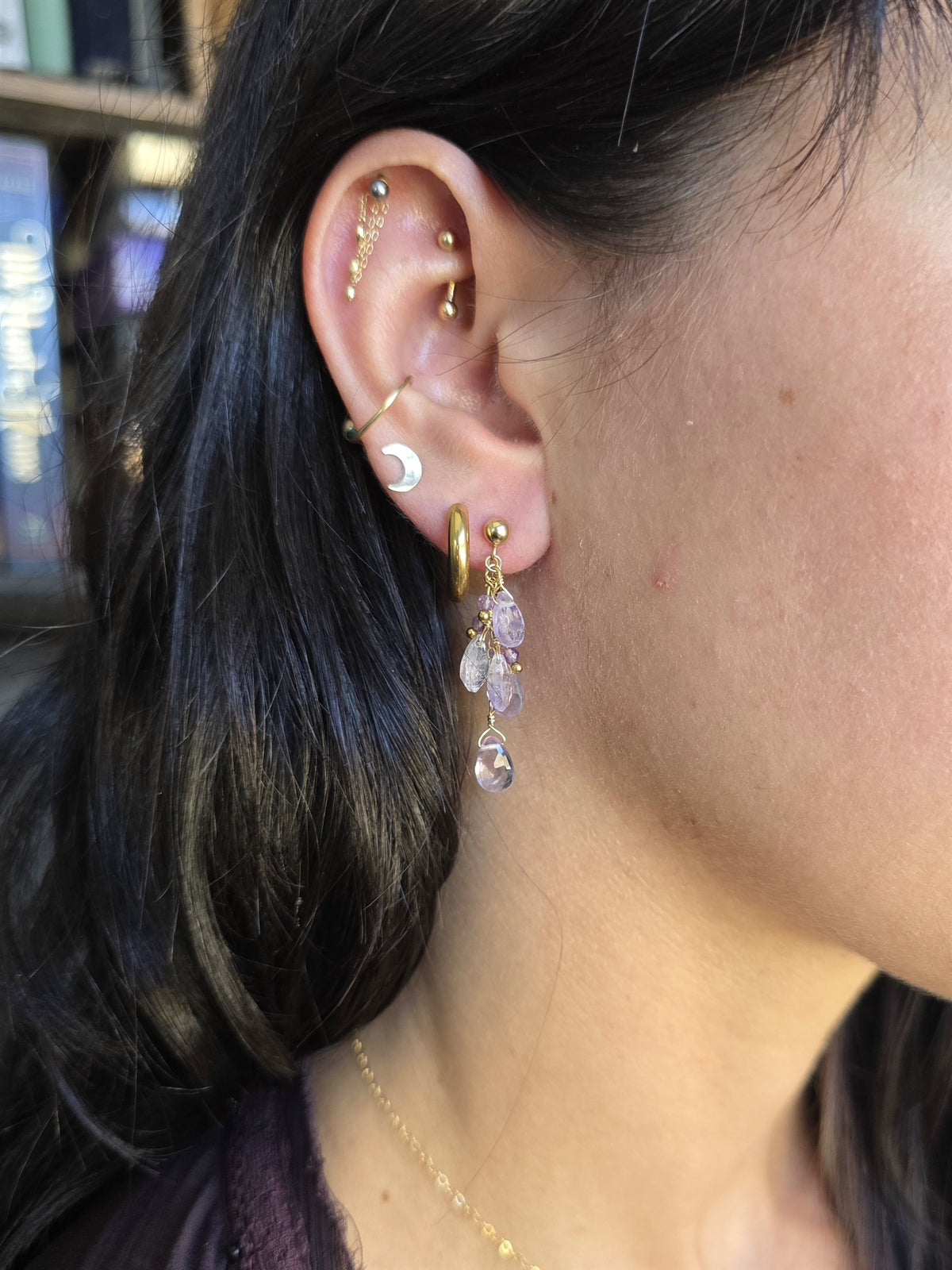 Amethyst cluster earring worn, side view