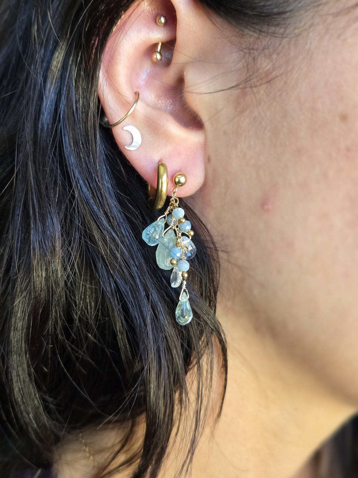 Aquamarine cluster earring worn, close-up