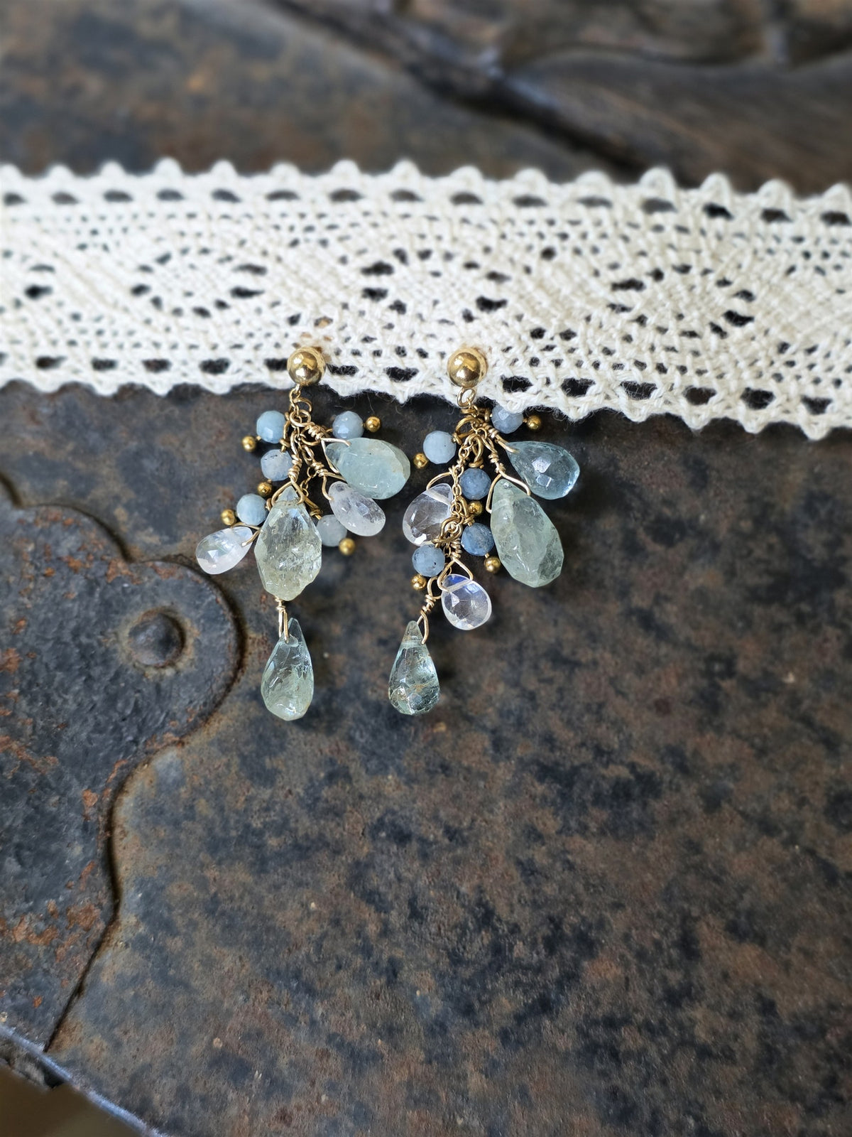 Aquamarine and moonstone cluster earrings, close-up