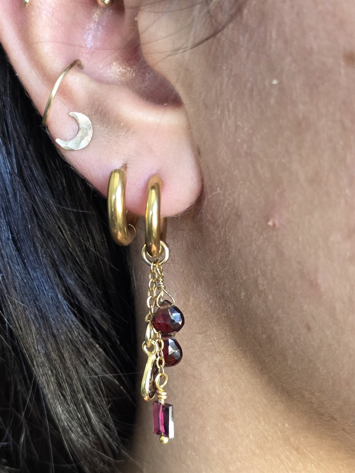 Garnet drop earring worn, angled view