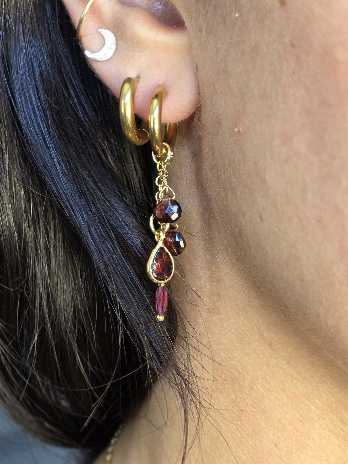 Garnet drop earring worn, profile view