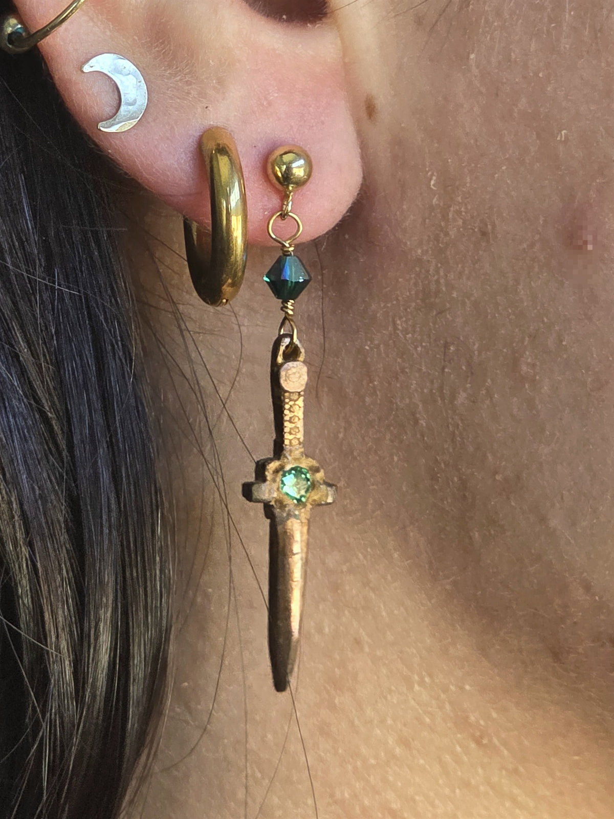 Forest dagger earring with dark green crystal, worn