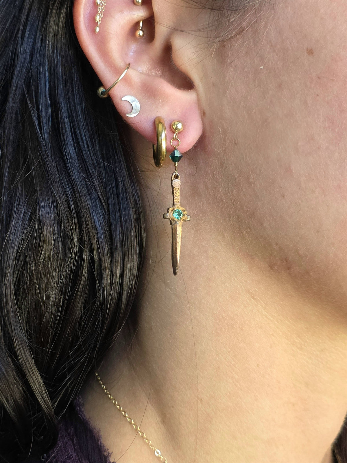 Bronze dagger earring worn, side view